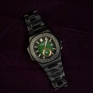 A luxury wristwatch with a green dial and metal bracelet placed on a dark purple velvet surface.