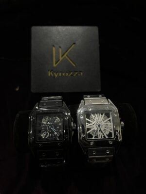 Two luxury Kyrozza wristwatches, one black and one silver, displayed on a black cushion with a Kyrozza box in the background.